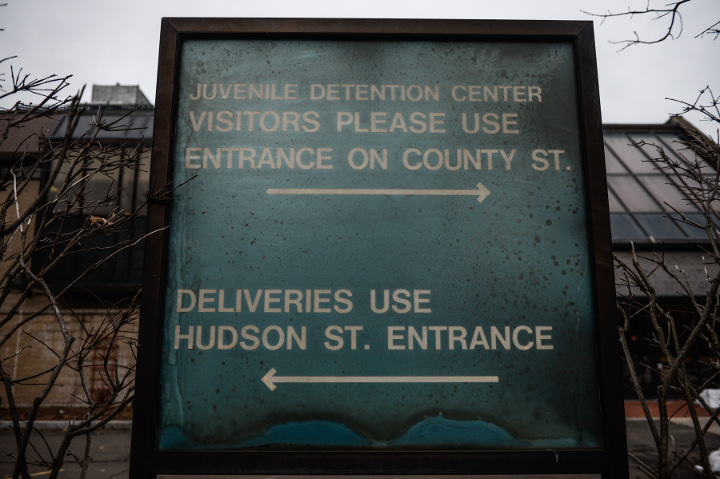 An aged sign at the entrance of State of Connecticut Superior Court for Juvenile Matters and Detention Center in New Haven, Conn. where detainees were once put in isolation before new laws were enacted. (Robert Stolarik for JJIE)