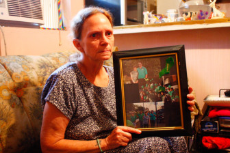 Kathy Hammons, Jaime's grandmother, displays a photo collage of Jaime taking part in an Egyptian Health Center event where he testified to counselors' ability to help him manage his anger. 