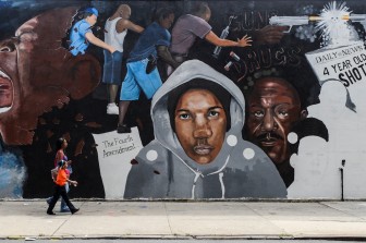 August 20, 2012 - Brooklyn, N.Y: People walk past a mural depicting the practice of Stop and Frisk on Livonia Avenue in the East New York section of Brooklyn. 
