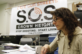 SOS Project Director Amy Ellenbogen sifts through statistics of shooting incidents within the group’s 40-block catchment area. 2012 saw a slight uptick in violence following two years of decline, but the overall number of shooting are down since the program launched in 2010.