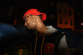 Eric Dawkins, 18, stands outside The Sapphire Lounge, on the Lower East Side, getting ready to perform at their monthly open mic night. Dawkins spent much of the last five years in a residential treatment center for kids with psychiatric issues and says music helped him express himself when he was away from home. 