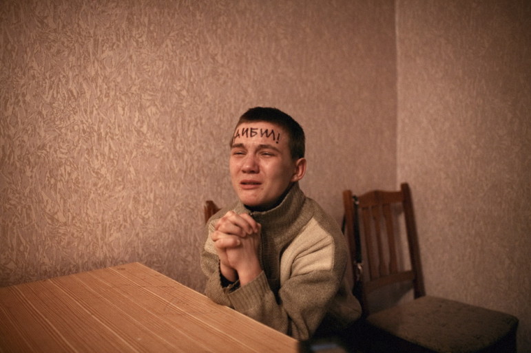 Vasily, just two weeks shy of his 16th birthday, is hauled in for questioning by the local police detective, feeling a sense of 'paternal devotion.' To humiliate him into submission, the detective wrote a Cyrillic word on his forehead which means cretin, imbecile, moron. On a downward spiral into larger and larger criminal activities, the detective threatened to send the boy into adult prison if he didn't straighten out. He has not committed a crime since.