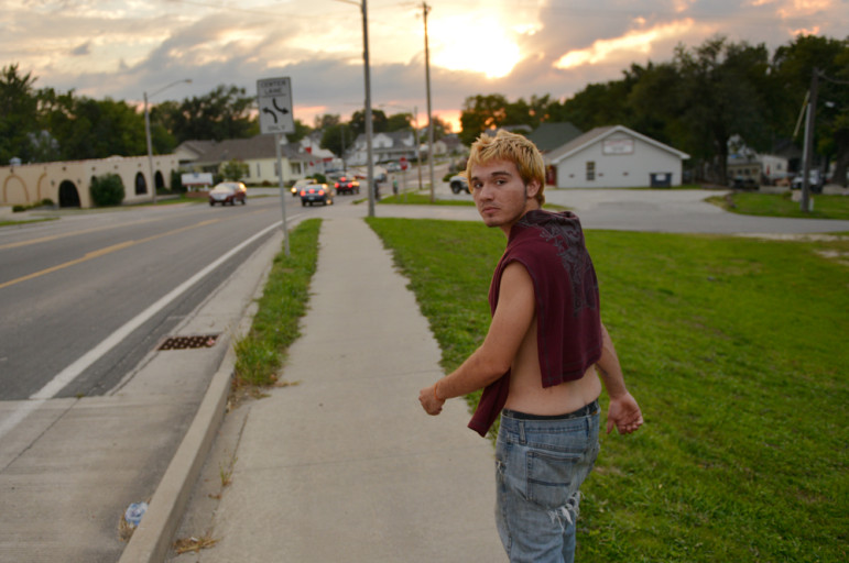 Vernon walks down 9th Street to visit a friend in a park. He roams shirtless whenever it’s warm enough to allow it.