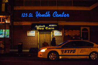 A man walks past the 125th Street Youth Center in Harlem on a recent evening.