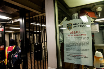 A sign on the elevated subway line on 125th Street asking for help in a recent attack.