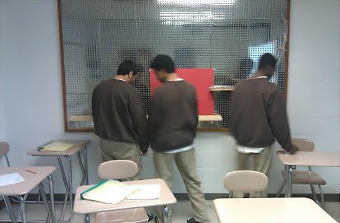 Youths work on a math and science activity board at the Metro Youth Service Center, a juvenile detention facility in Boston. The Massachusetts Department of Youth Services banned punitive solitary confinement in 2009. To reduce the use of solitary confinement, experts say, it’s critical to keep youngsters occupied in engaging programs.
