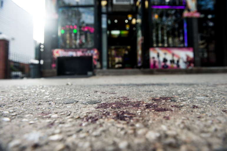 A blood stained sidewalk outside the Bronx store where Javier Payne, 14, was allegedly pushed through a glass window by police.