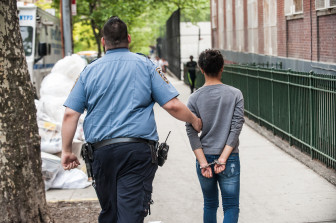 A young girl is handcuffed and placed under arrest outside Public School 22 Wednesday afternoon in the Bronx where Javier Payne attends the 8th grade. 