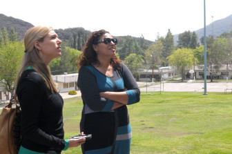 Michelle Newell of the Children's Defense Fund (left) and Dalila Fragoso, Probation Director of Camp Kilpatrick (right), talk about the future of the camp (in background).