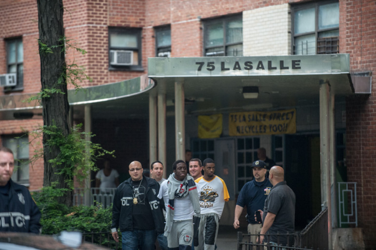 Members of the NYPD raid the Manhattanville Houses and the Grant Houses in West Harlem early on the morning of June 4, 2014. A total of 40 suspects were arrested as part of a massive 145-count indictment of 103 people in a range of crimes, including murder, 19 shootings, gang assaults, beatings and conspiracy. Police apprehend suspects at the Grant Houses. 