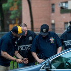 Members of the NYPD raid the Manhattanville Houses and the Grant Houses in West Harlem early on the morning of June 4, 2014. A total of 40 suspects were arrested as part of a massive 145-count indictment of 103 people in a range of crimes, including murder, 19 shootings, gang assaults, beatings and conspiracy.