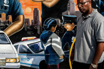 The killing of Tayshana Murphy on September 11, 2011 sparked a feud  between The Manhattanville Houses and the Grant Houses in West Harlem leaving stretch of a street along Old Broadway a virtual war zone. Taylonn Murphy, father of the slain girl walks past a mural near a police precinct.