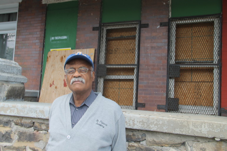 Moore says he's disheartened by the rioting that occurred blocks from these boarded-up row houses.