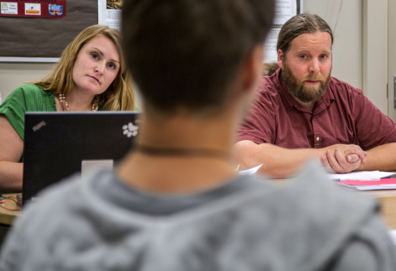 During a session with a student at Spokane’s North Central High School, truancy board members Macy Pate and Justin Mauger listen intently as the teen explains why he was missing school. Pate is a counselor at the school. Mauger works for the local YMCA. (Steve Ringman / The Seattle Times)