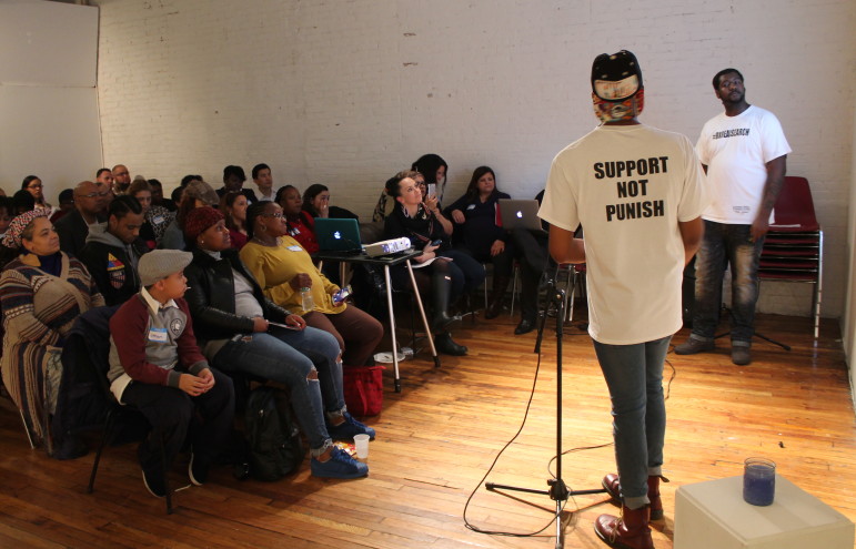 Report co-authors Charles Hudgens (right) and DeVante Lewis (back to camera) explain its findings at the Bronx Art Space.