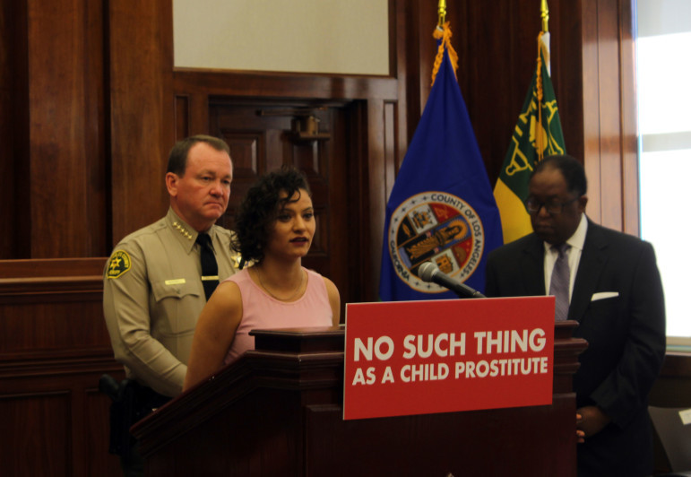 McDonnell (left) and Pettigrew (at lectern) were at the announcement of the No Such Thing As a Child Prostitute campaign. 