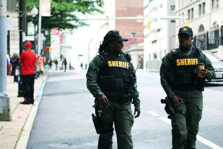 Two officers of the Baltimore County Sheriff's Office on patrol in front on the courthouse, in occasion of the trial of Baltimore Police Department Officer Caesar Goodson. The city reacted to fears of unrest following the trial’s verdict by deploying a large number of law enforcement agents.
