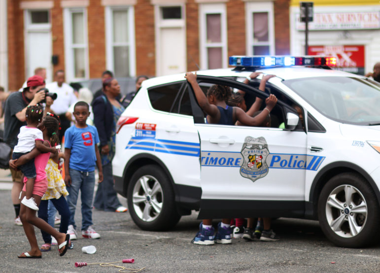Children playing around a police car near the intersection of West North and Pennsylvania avenues in Baltimore. The intersection has been the stage of the uprising following the death of Freddie Gray in April 2015.