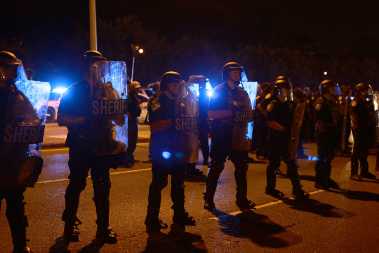 Sherif deputies in riot gear deployed to respond to protesters gathered in front the Baton Rouge Police Department headquarter. 