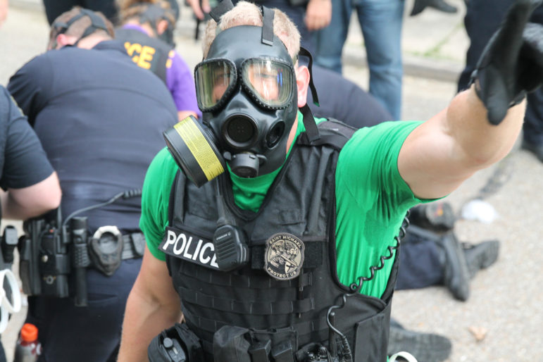 An officer demanding a JJIE reporter standing on private property move or be arrested during a protest in Baton Rouge on July 10, 2016. Protesters are calling for justice for Alton Sterling, who was killed by Baton Rouge police on July 4, 2016.