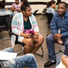 Mentoring program works: Young people sit in circles and talk.