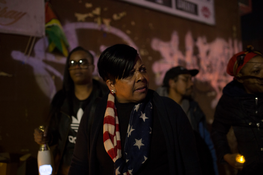Kimani Gray’s mother in American flag-themed scarf looks to right, looking troubled.