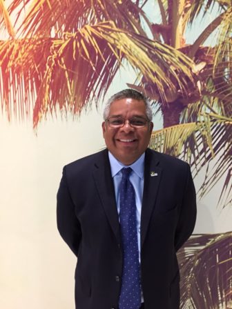 Franco Vega (headshot), RightWay Foundation’s executive director; smiling with gray hair, glasses, dark suit, light blue shirt, dotted dark blue tie.