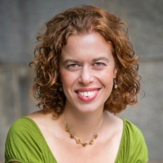Gun control: Katy Rubin (headshot), executive director of Theatre of the Oppressed NYC, smiling woman with brown curly hair, lipstick, green top.