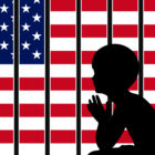 immigration: Silhouette of child behind bars with American flag on other side.