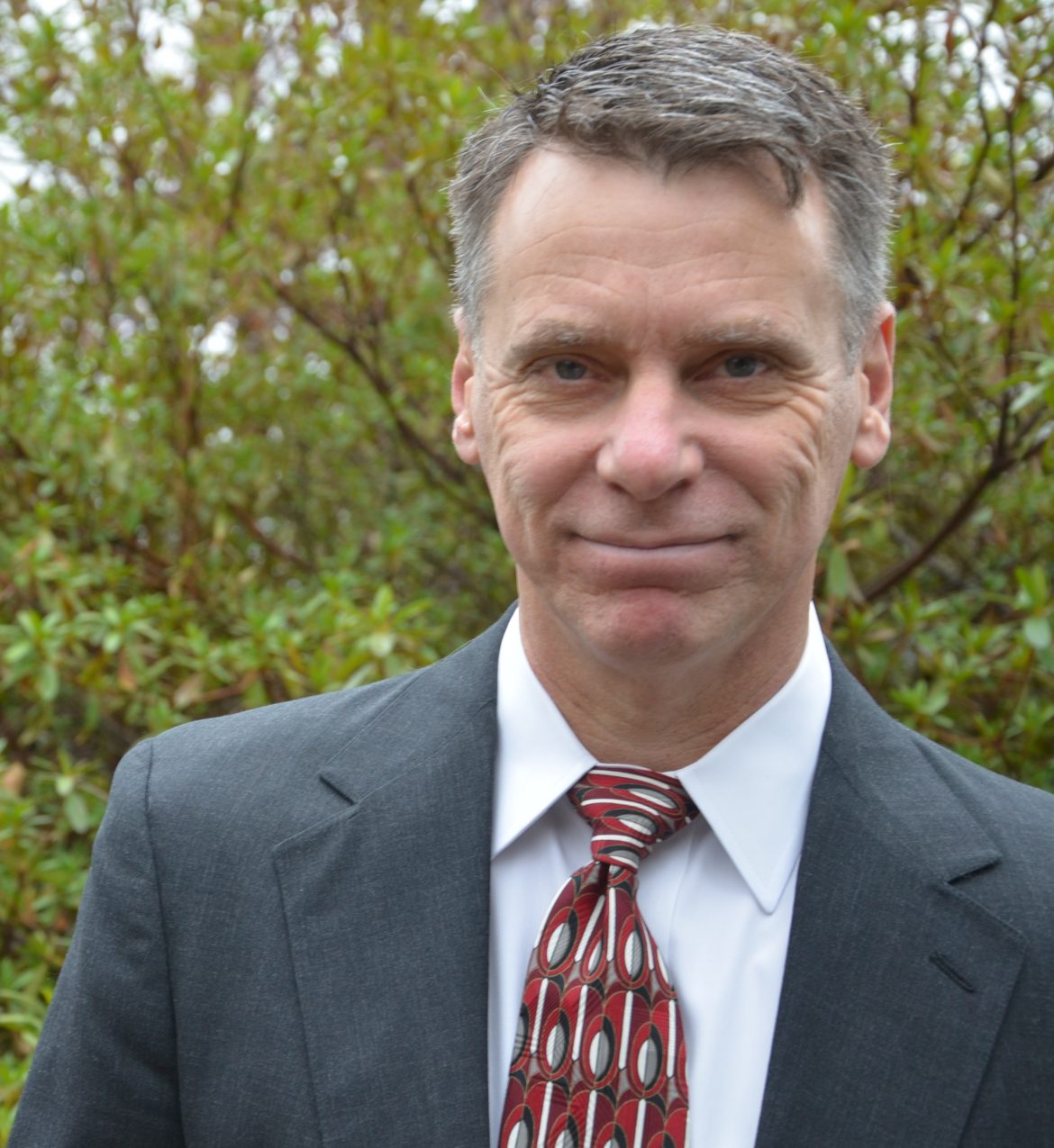 community-based alternatives: Dan Edwards (headshot), president of Evidence-Based Associates, smiling man with short gray hair, gray jacket, white shirt, striped tie