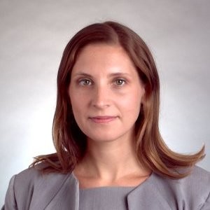 fees and fines: Christina Gilbert (headshot), senior staff attorney at National Juvenile Defender Center, woman with medium-length brown hair, gray suit