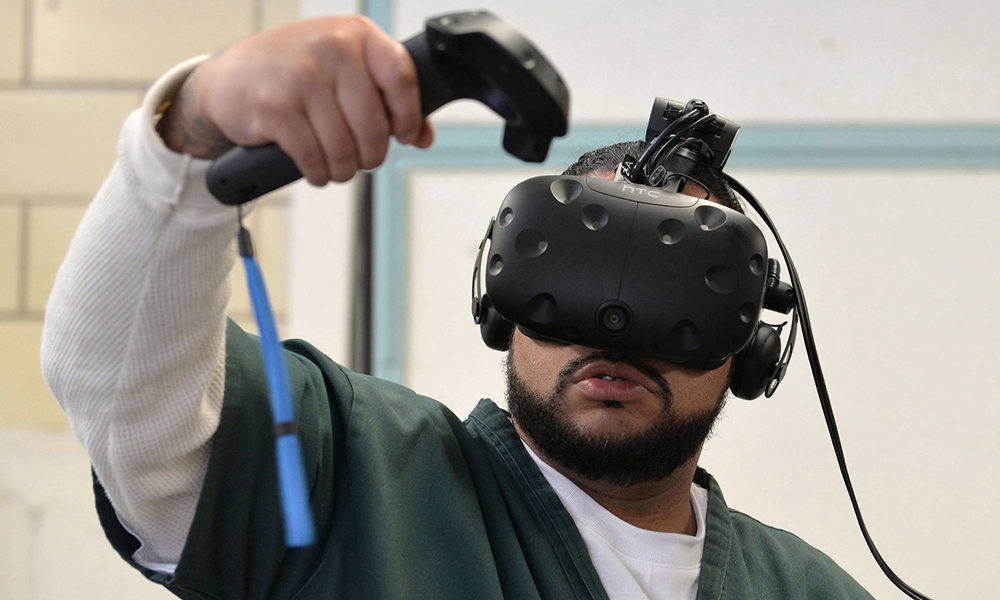 virtual reality: Man with beard, mustache, wearing short-sleeved green top over long-sleeved white top uses virtual reality headset