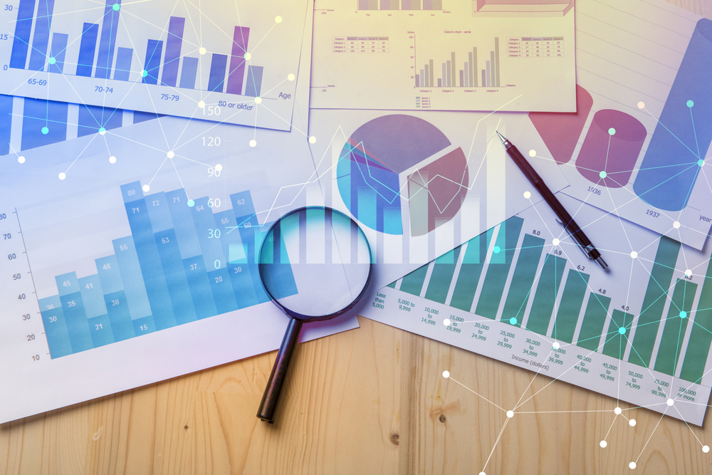 evidence-based practice: Magnifying glass and documents with analytics data lying on table