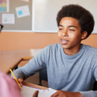 assessment tools: High School Tutor Giving Male Student One To One Tuition At Desk