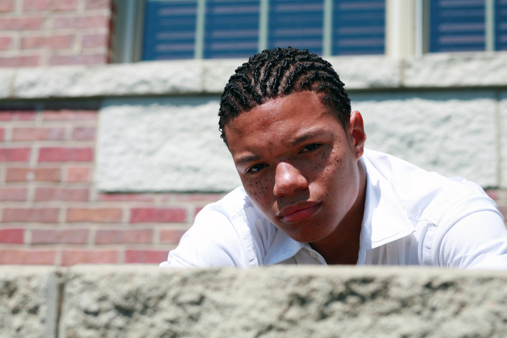 diversion: Close-up of scowling African-American teen boy with cornrows