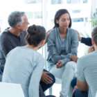 mental health: Concerned people comforting each other at a therapy session