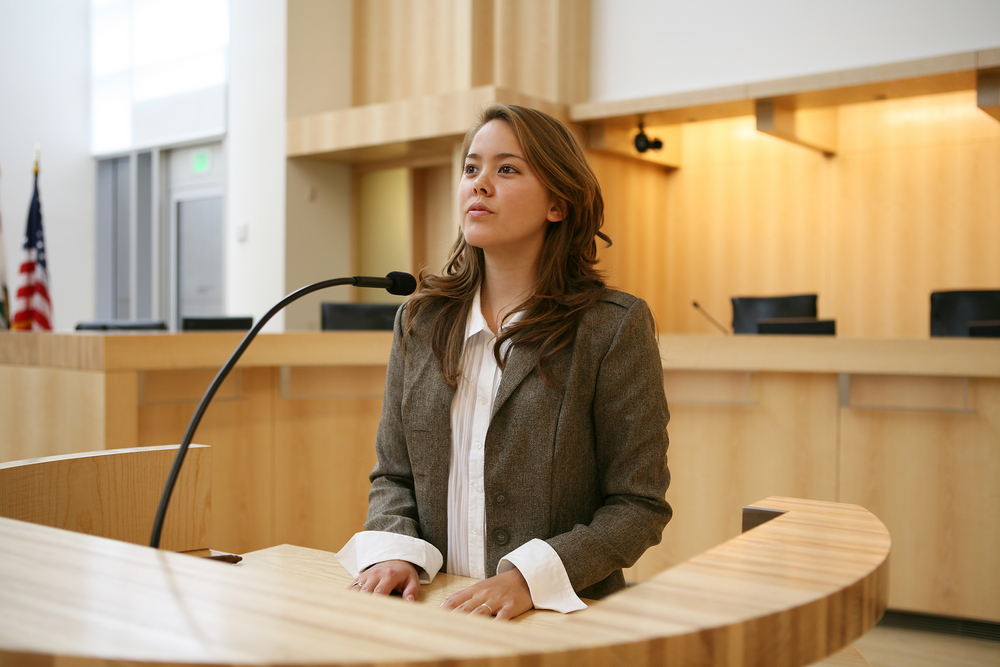 Young woman speaking at lectern