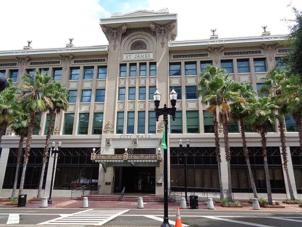 Jacksonville: Building with palm trees on sidewalk.