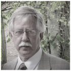 parole: man with gray hair, mustache, glasses in suit and tie