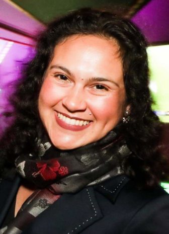 San Francisco: Alex Barrett-Shorter (headshot), communications and policy intern at Center on Juvenile and Criminal Justice, smiling woman with dark hair, earrings, shamrock scarf.
