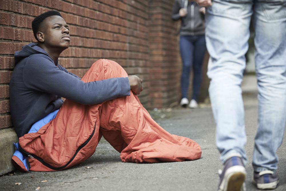 LGBT: Homeless Teenage Boy In Sleeping Bag On The Street