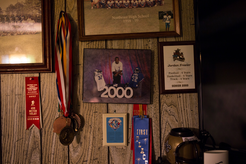  Photos, medals hang on wall.