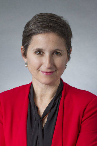 Arizona: Mary Ann Scali (headshot), executive director of National Juvenile Defender Center, smiling woman with short brown hair, earrings, red jacket, black blouse. 