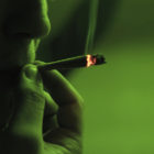 marijuana: young guy smoking a rolled joint