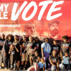 vote: People wearing let my people vote T-shirts stand in front of bus with same motto