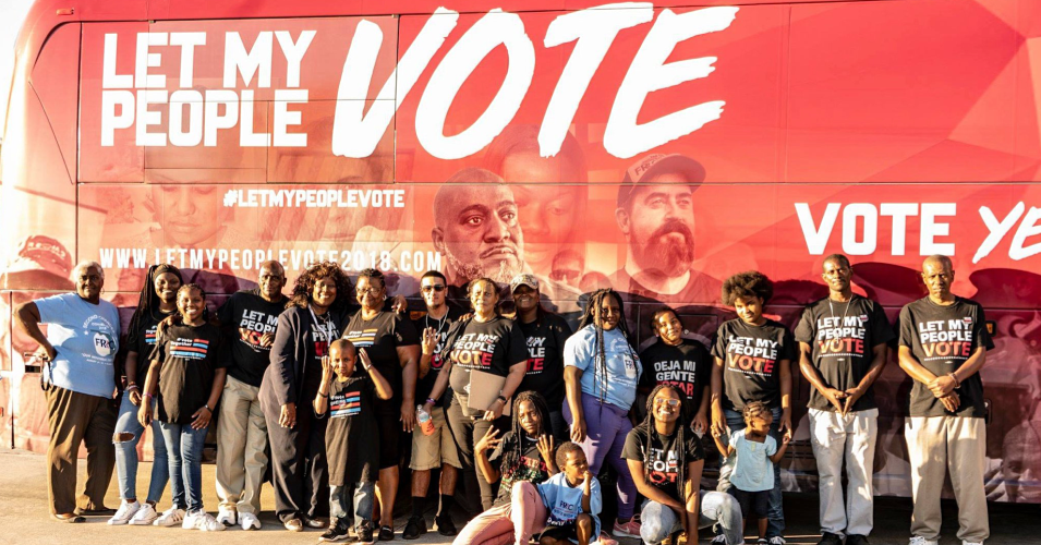vote: People wearing let my people vote T-shirts stand in front of bus with same motto