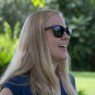 dog training: Smiling blond woman in sunglasses outdoors