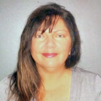 Florida: Denise Rock (headshot), executive director of Florida Cares, smiling woman with long brown hair, gray top.