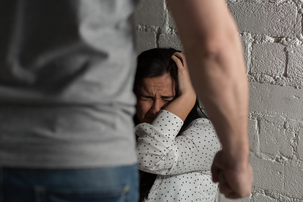 abuse: domestic violence, abuse and people concept — man beating helpless scared girl