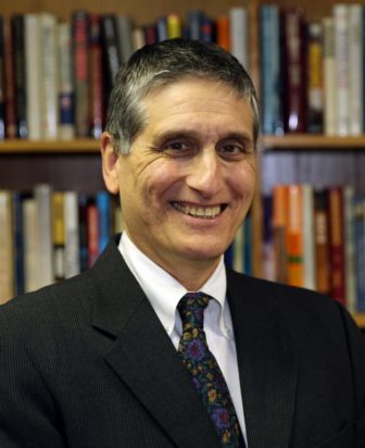 North Carolina: Smiling man with short graying hair in suit